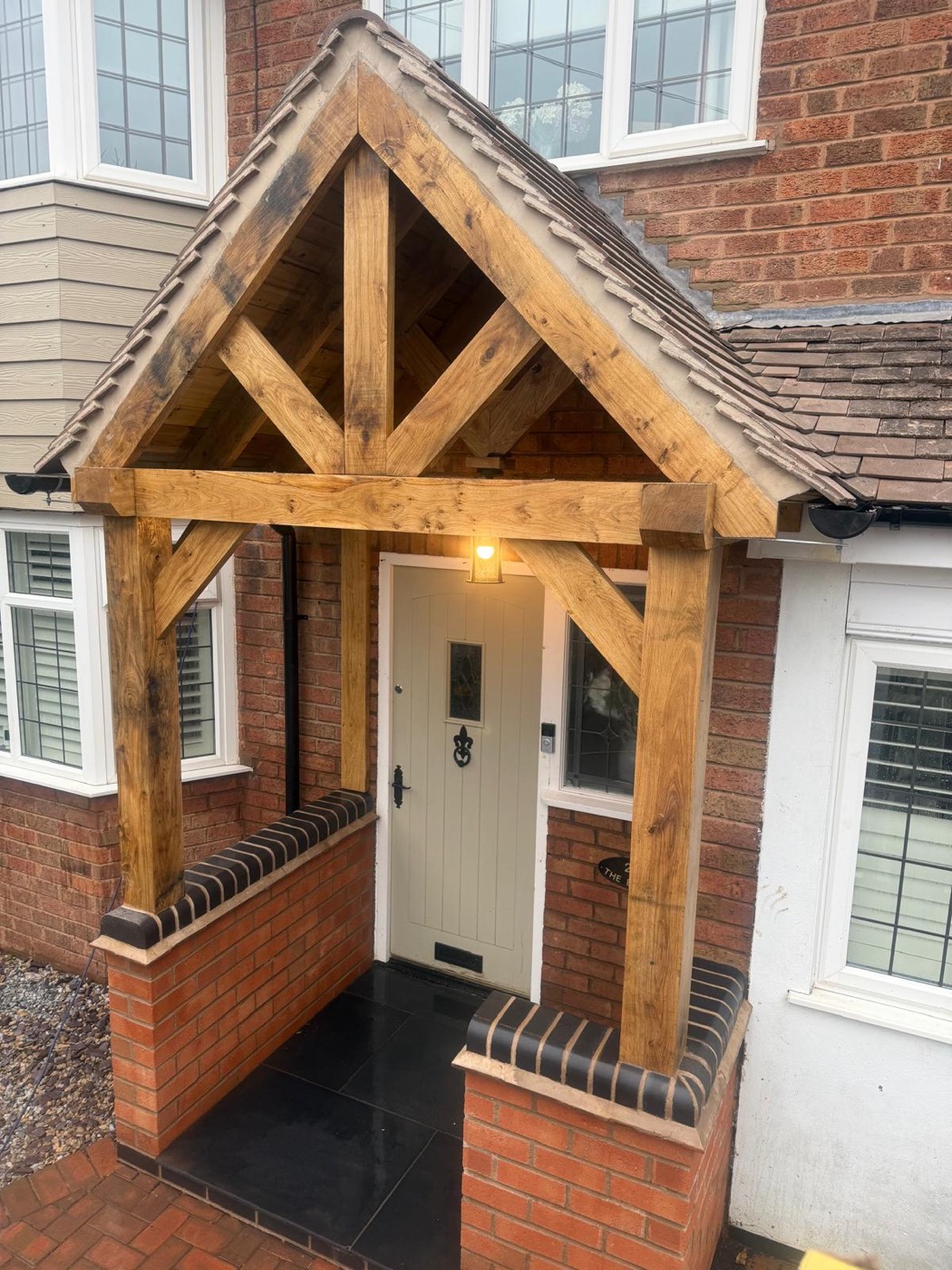 Completed oak porch by Trio Construction Group